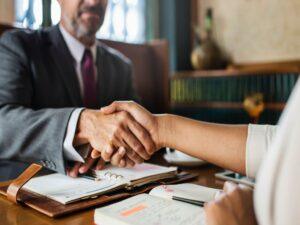 Two people shaking hands during a business meeting.